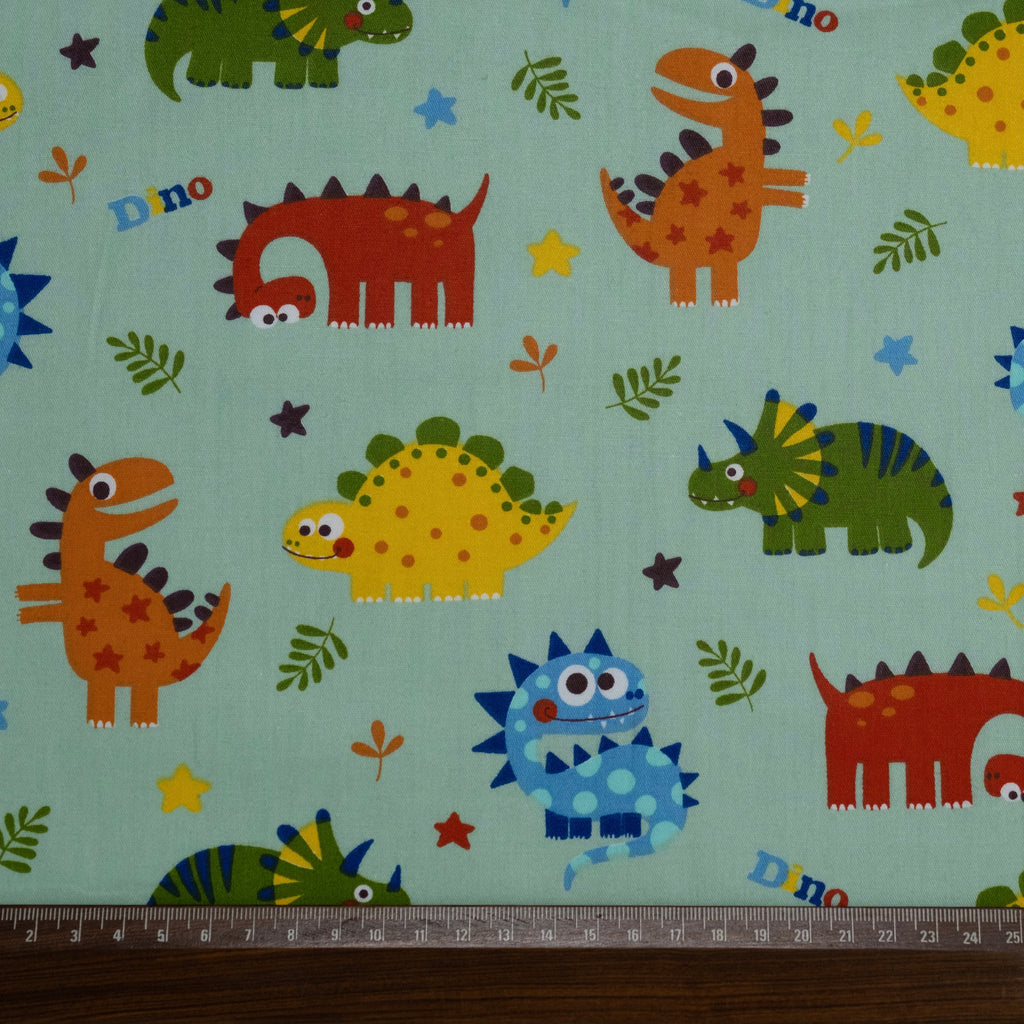 Popeline imprimée de dinosaures rigolos pour enfants, verte
